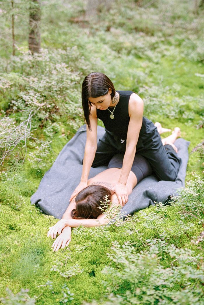 Home A serene outdoor massage session in a lush forest setting promoting relaxation and wellness.